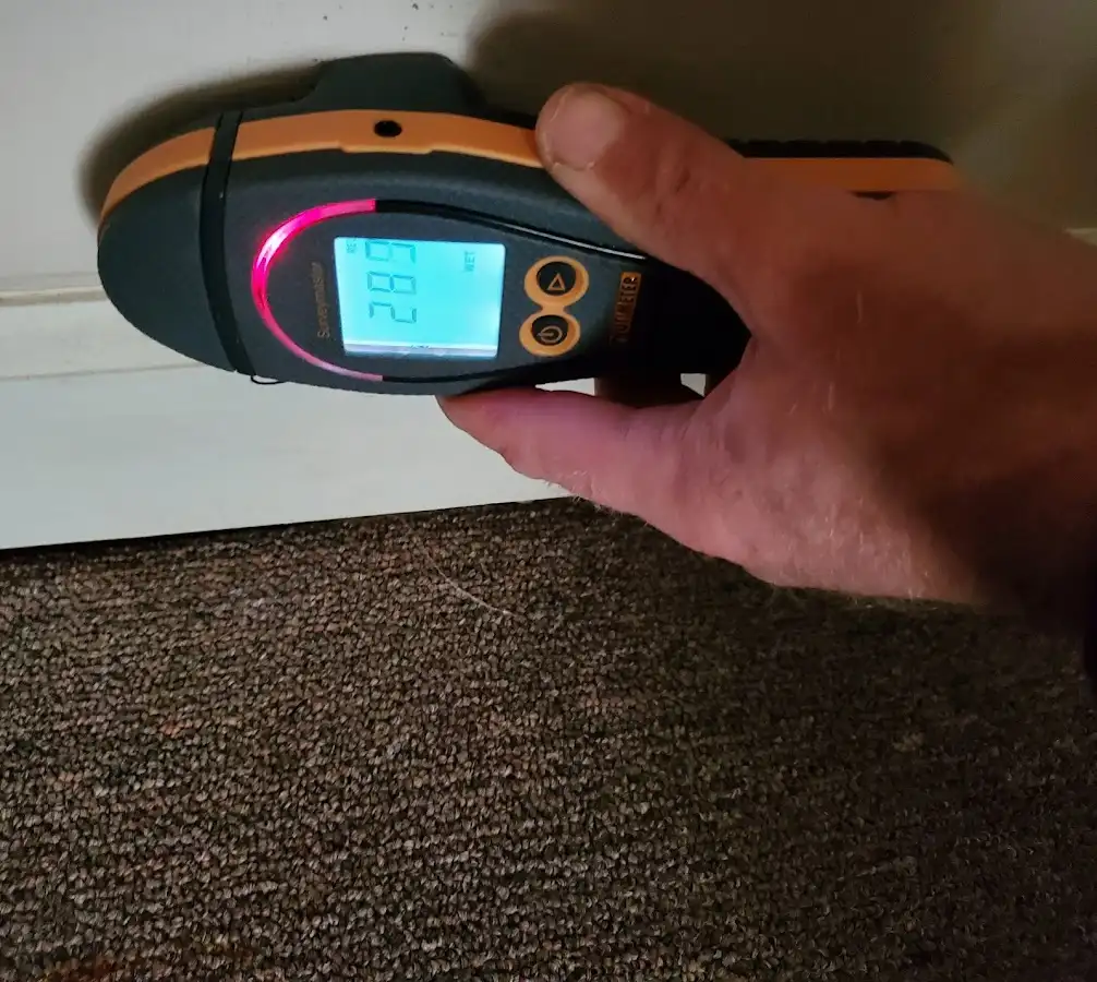 Moisture detection at baseboard during Storm Damage Restoration in Lakewood Ranch